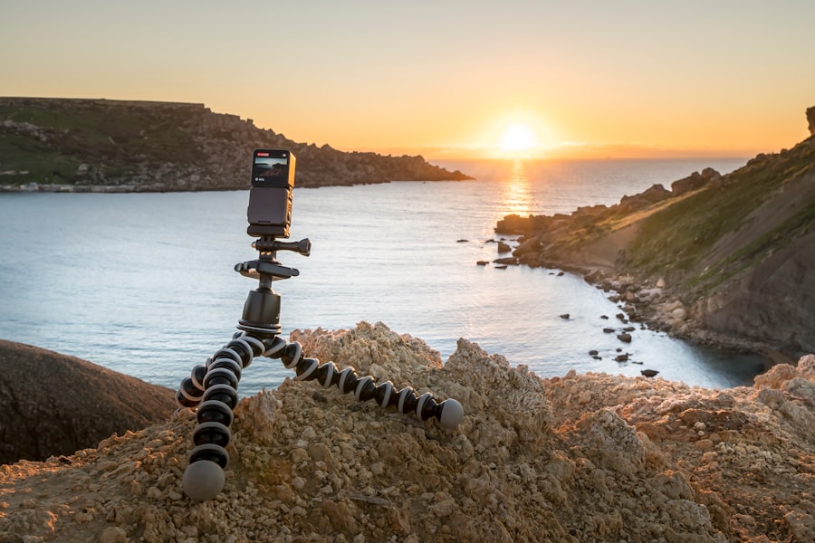 Camera on tripod overlooking ocean at sunset