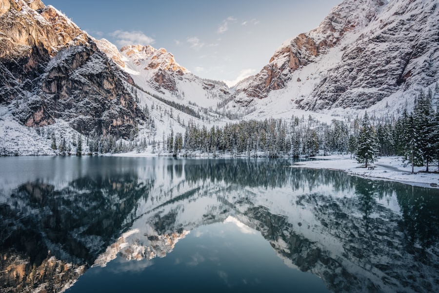 snow covered mountain near lake during daytime