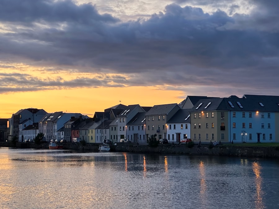 Colorful houses line a waterfront at sunset
