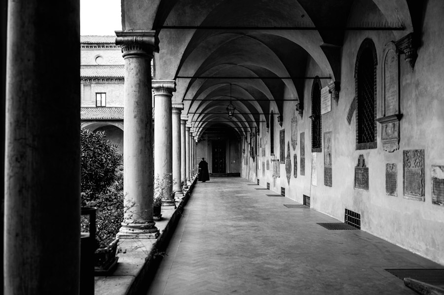 a black and white photo of a long hallway