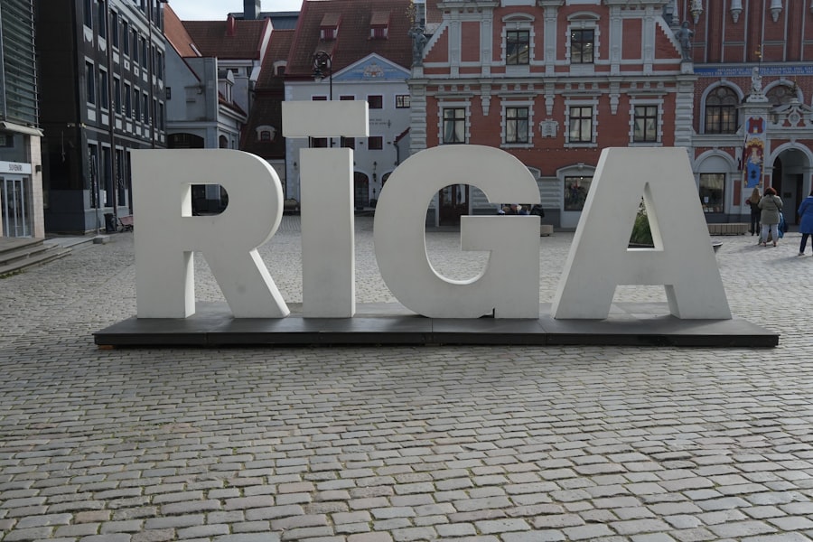 A large sign that reads riga on a cobblestone street