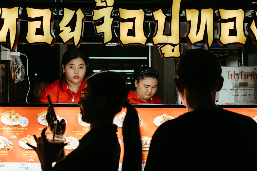 A group of people standing in front of a food truck