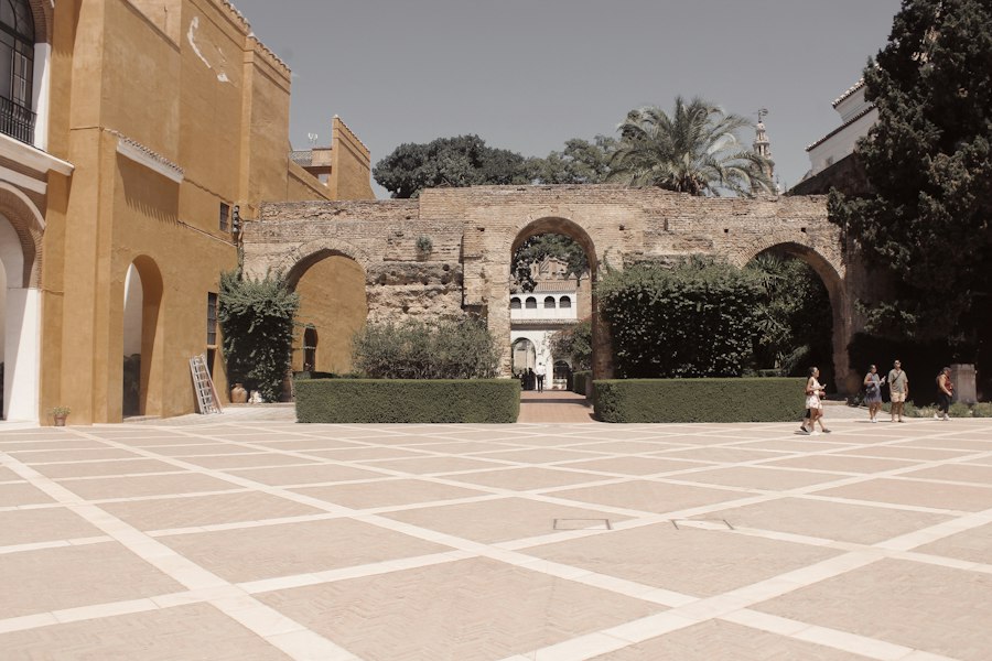 Courtyard with historic arches and manicured hedges