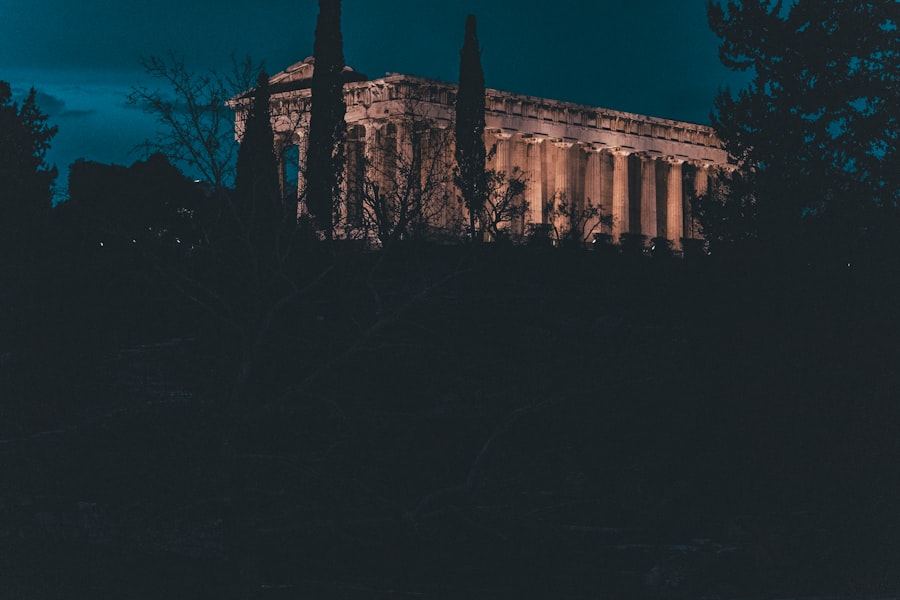 Ancient temple illuminated at night with dark sky