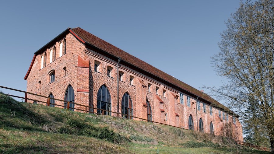 Old brick building with arched windows under blue sky