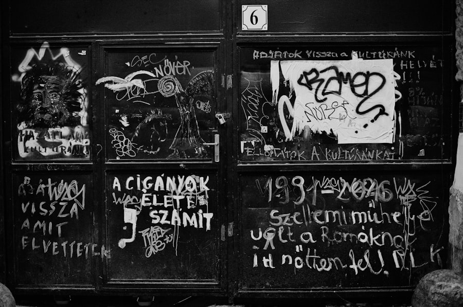 a black and white photo of graffiti on a door