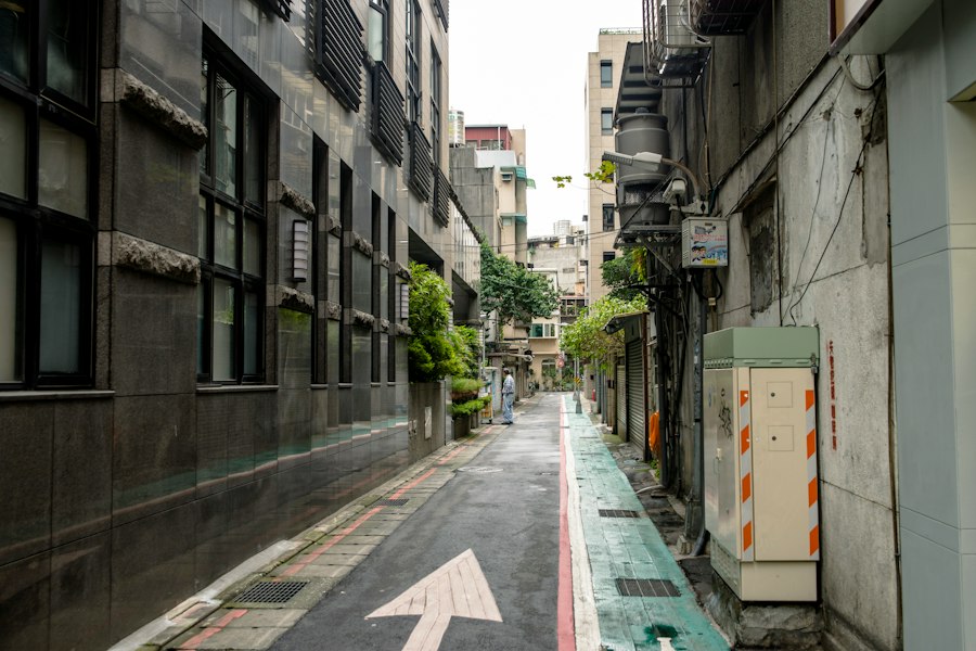 a narrow city street with an arrow painted on it