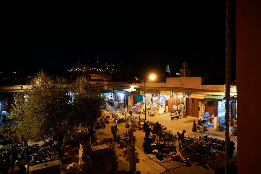 a street with people and buildings at night