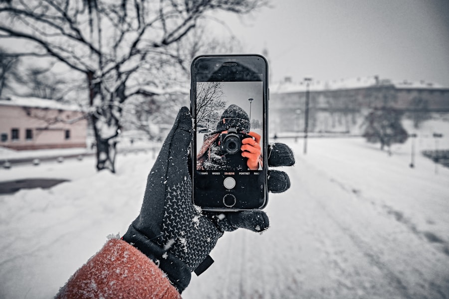a person taking a picture of a snow covered street