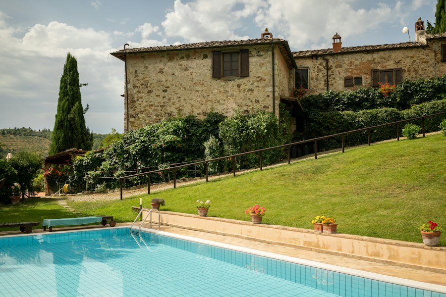 a house with a pool in front of it