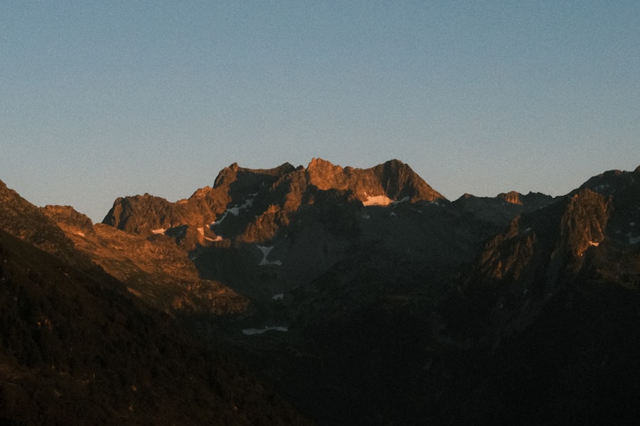 Majestic mountain peaks glowing orange under a clear sky
