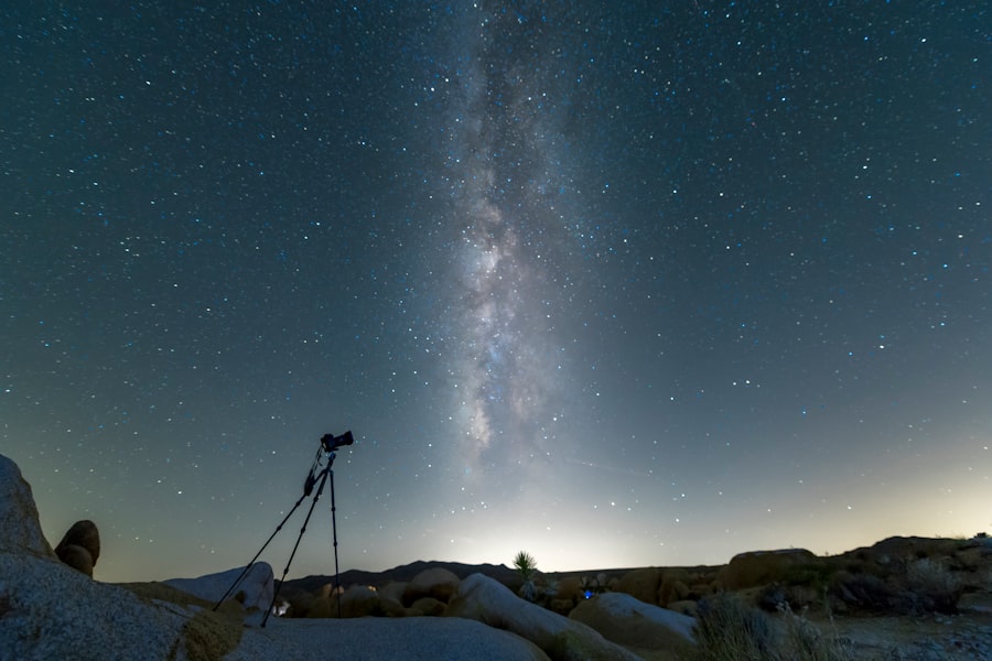 black tripod on snow covered ground under starry night