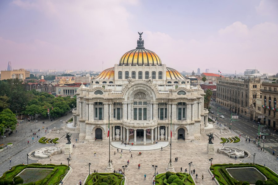 Grand ornate building with golden dome and city background