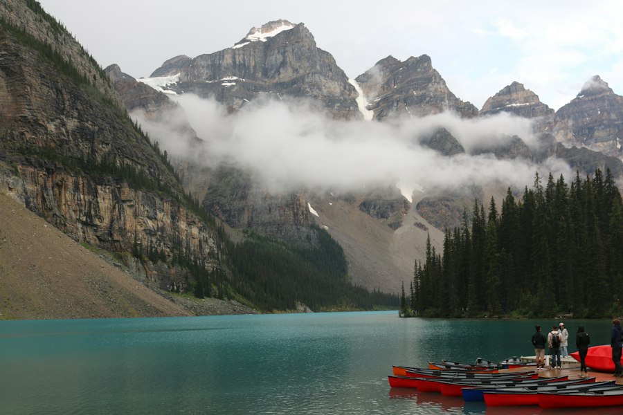 Turquoise lake with mountains and pine trees