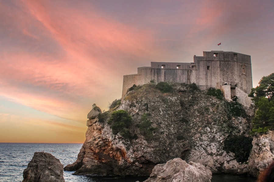 Fortress on a cliff overlooking the sea at sunset