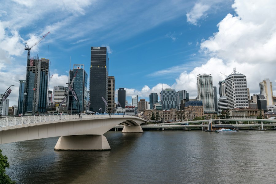 white bridge over river near city buildings during daytime