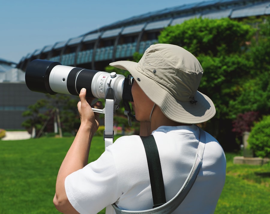 Person with large camera lens photographing building