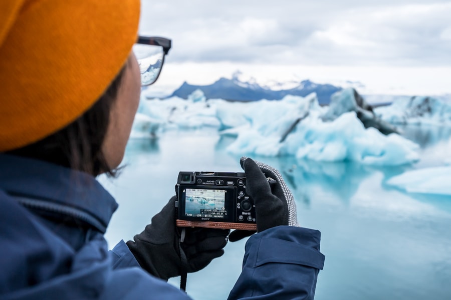 Person photographs icebergs in glacial lagoon