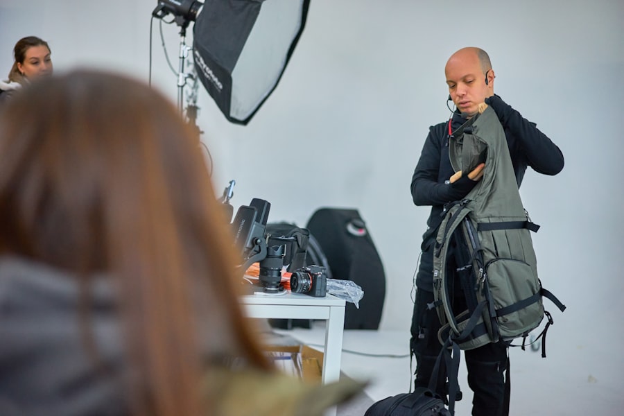 A man standing in front of a camera in front of a woman