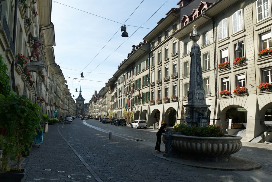 A city street with a statue in the middle of it