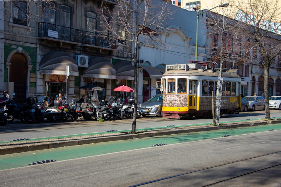 A yellow tram travels down a city street.