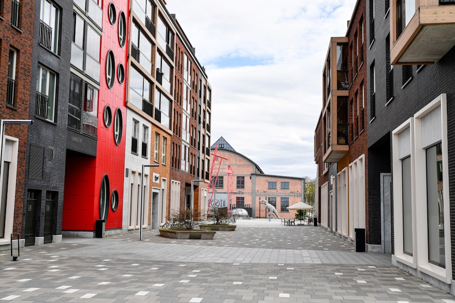 Modern buildings line a paved walkway with outdoor seating