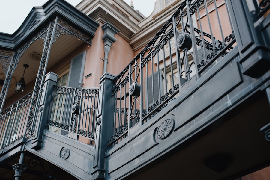 Ornate ironwork balconies and stairs on an old building.