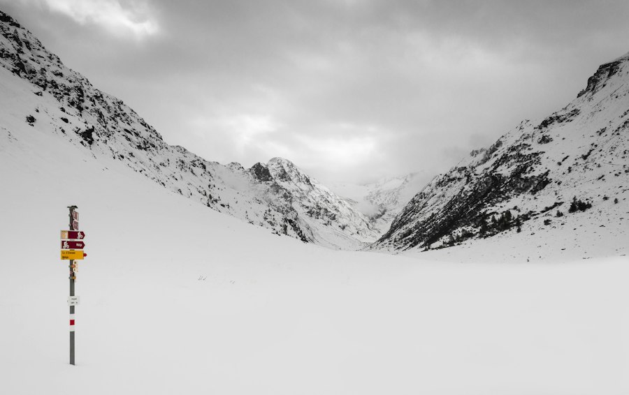 snow covered mountain under cloudy sky during daytime