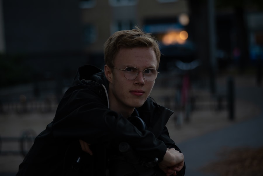 a man wearing glasses and a black jacket
