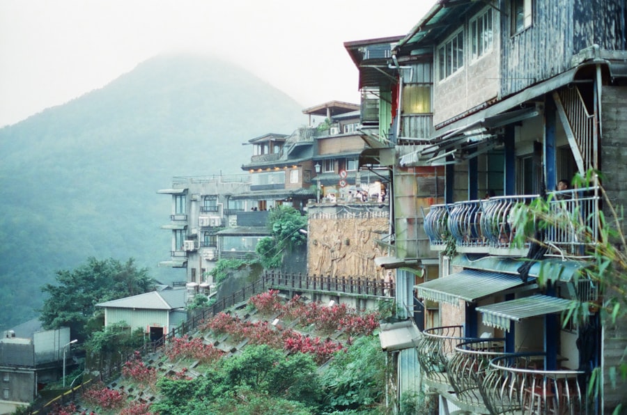 Houses climb a hillside in a scenic mountain village.