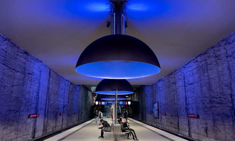 a couple of people sitting on a bench under a blue light