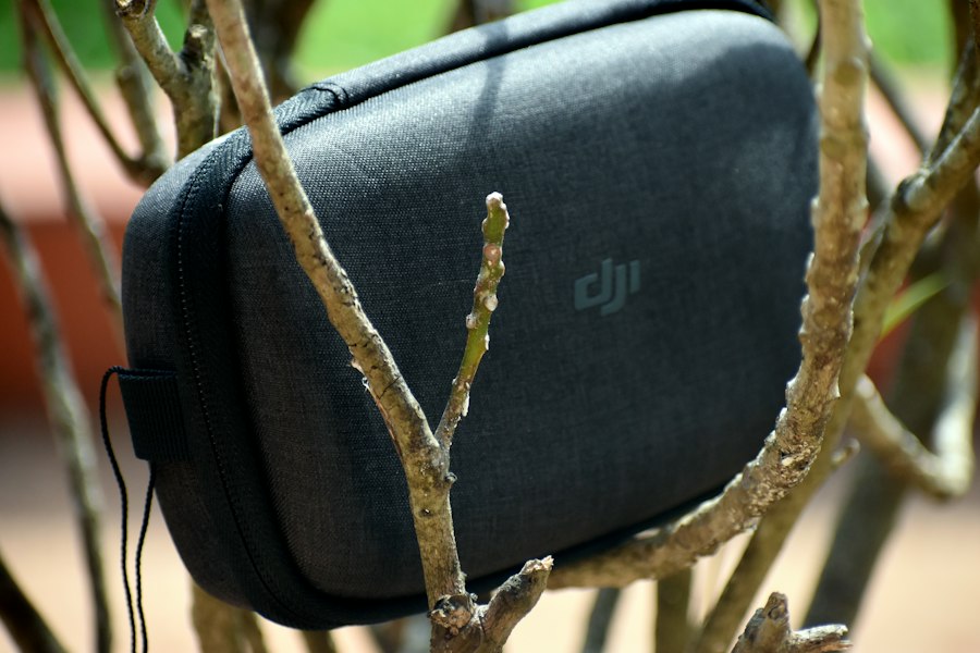 gray DJI case on branch of tree