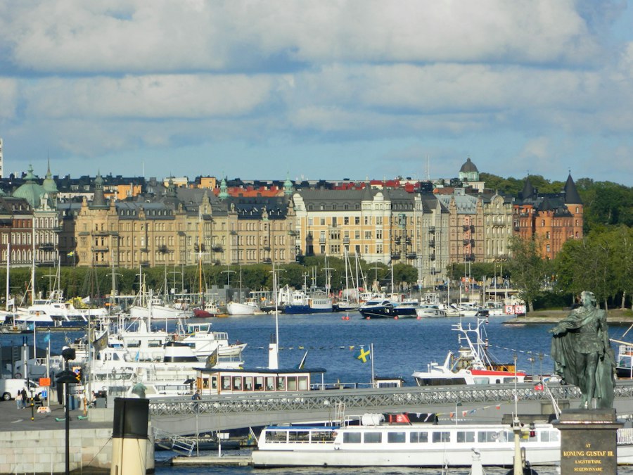 Boats docked in a harbor with city buildings behind