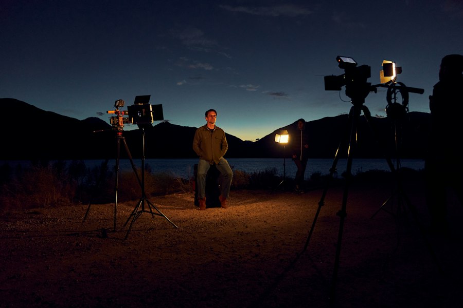 a man sitting on a chair in front of a camera