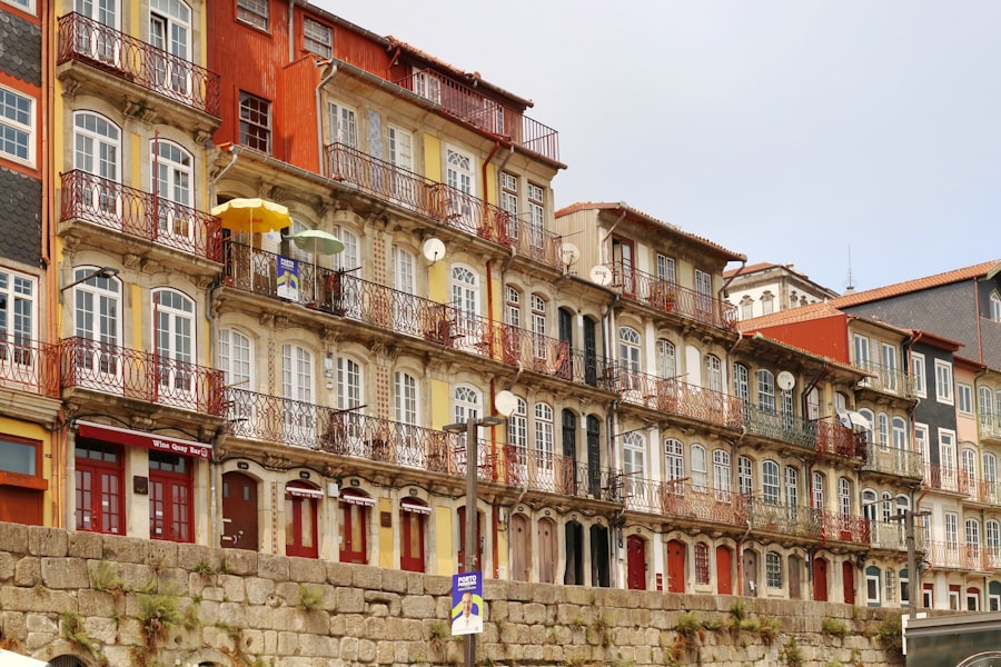 Colorful buildings line a stone embankment by the water.