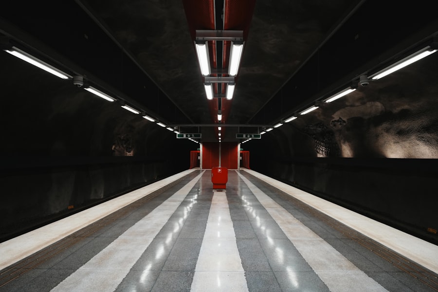 Modern subway station with striped platform and red accents