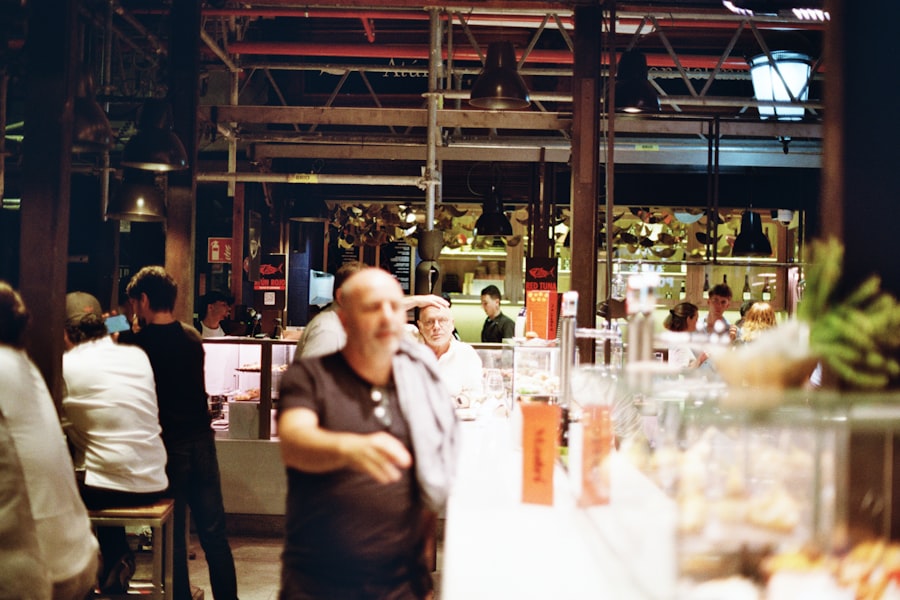 A group of people standing around a bar