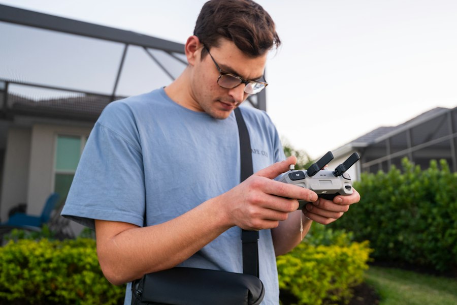 A man standing outside looking at his cell phone