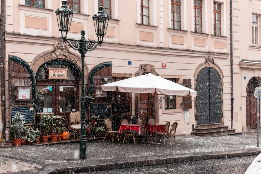 a couple of tables and chairs under a white umbrella