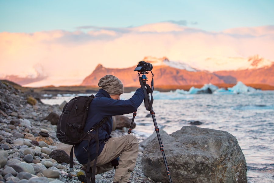 a man with a camera on a rocky beach