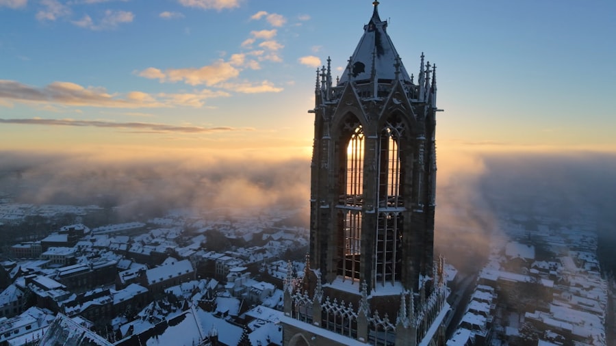 Gothic tower at sunrise with snowy cityscape