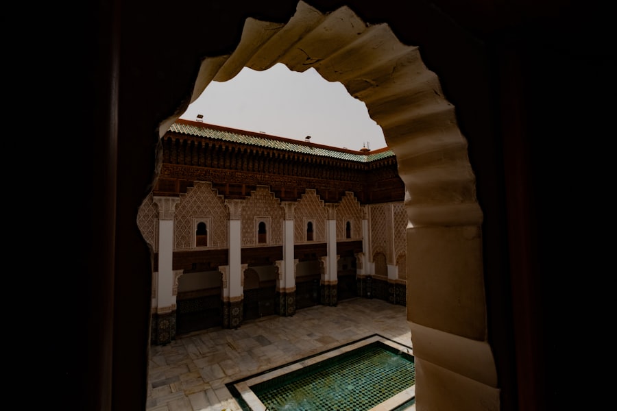 Courtyard with ornate arches and a pool.