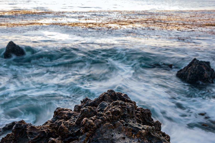 A rocky beach with waves coming in and out of the water
