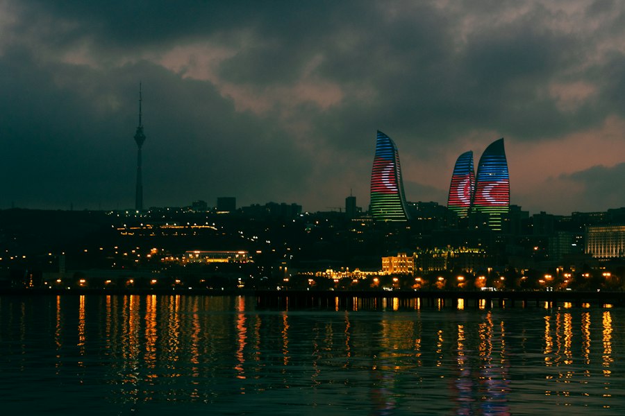 Baku cityscape at night with illuminated flame towers and reflections