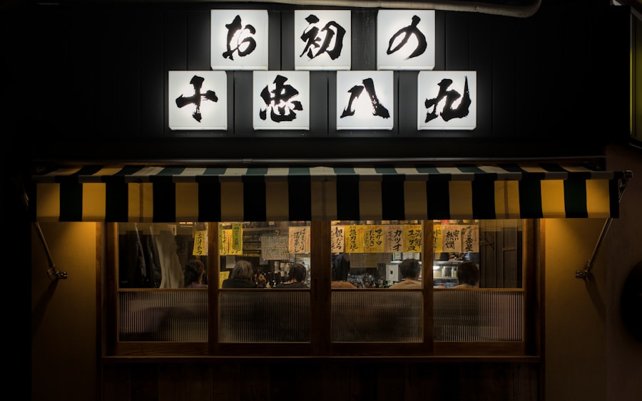 Japanese restaurant storefront at night with illuminated signs.