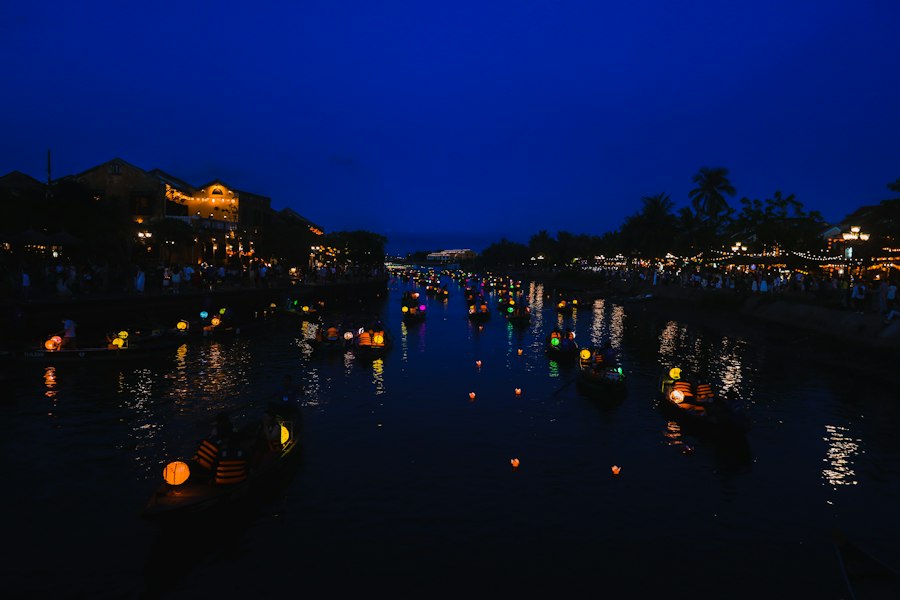 Lamps float on a dark river at night