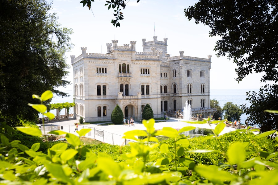 A grand white castle surrounded by lush green foliage