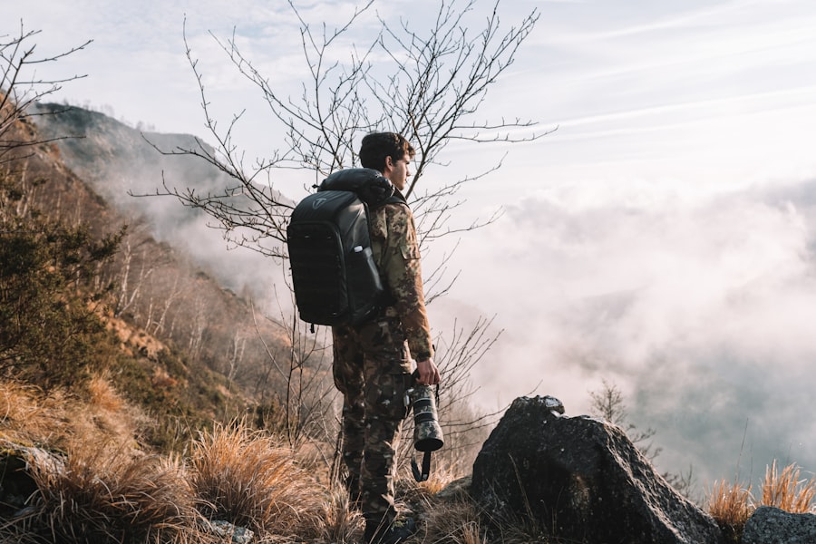 a man with a backpack standing on top of a mountain