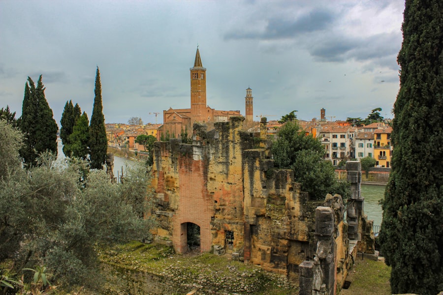 The ruins of a building with a clock tower in the background