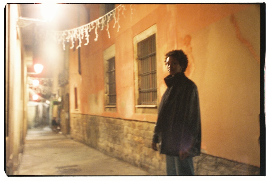 A man standing on a sidewalk next to a building